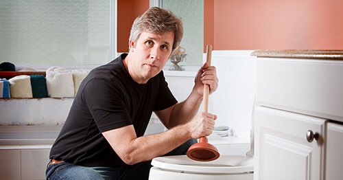 What to Do When You Clog Someone Else’s Toilet